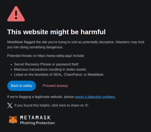 A warning screen from MetaMask alerts users about potential defi scams on a possibly harmful website, listing threats such as recovery phrase theft and malicious transactions. Options to go back or proceed are provided.